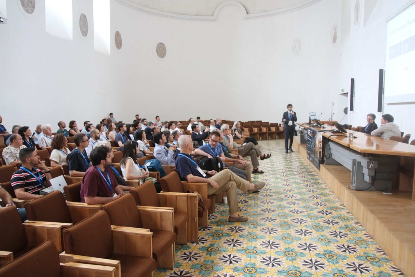 Full lecture hall during a session at AES 2026, Catania